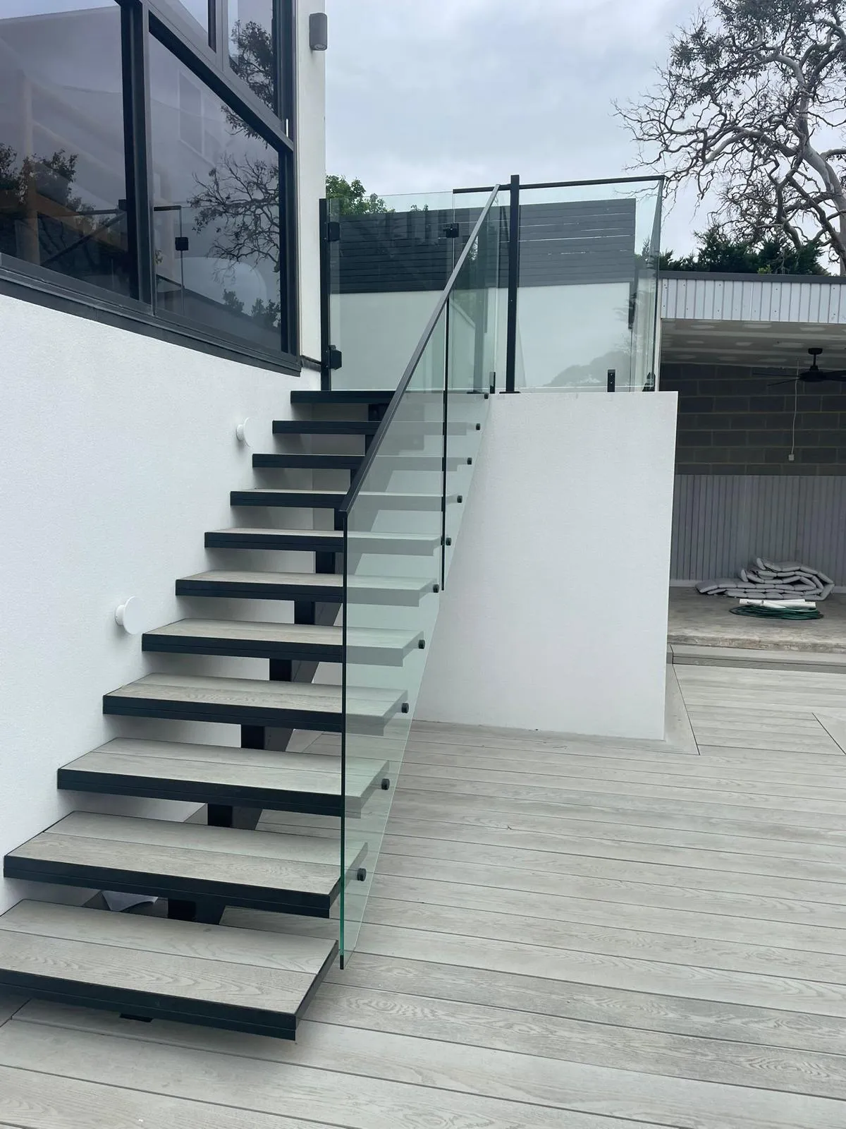 Floating timber stair with a frameless glass balustrade in Toorak
